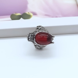 Detailed view of Gothic silver dragon ring featuring a large oval red gemstone setting