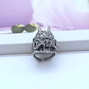 Close-up of vintage dragon head relief on an adjustable retro stainless steel ring