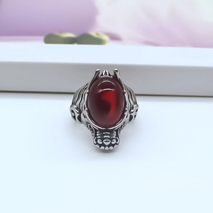 Detail view of retro silver alloy dragon ring with large oval translucent red stone