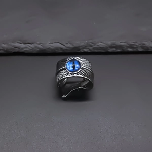 Punk style feather open ring for men featuring a blue evil eye stone in silver finish