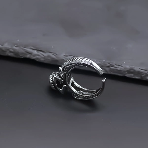 Detailed macro view of retro silver alloy ring with Gothic embossed textures and open band