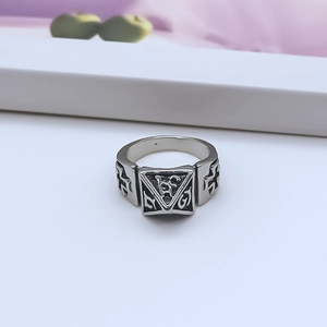 Macro shot of silver punk ring with pyramid motif and side cross cutout details