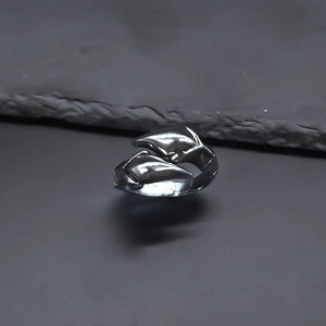 Detailed macro view of silver alloy punk ring featuring intertwined dolphin design