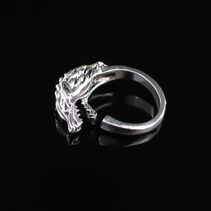 Macro shot of a vintage silver wolf head ring with detailed carving and adjustable open band