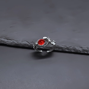 Macro detail of punk style silver adjustable ring with a vibrant red crystal stone