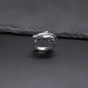 Detailed close-up of a vintage wolf head ring with intricate punk-style engraving