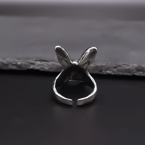 Close-up of a silver bunny ear open ring with adjustable minimalist geometric design