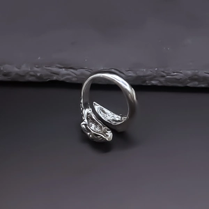 Detailed view of silver punk skull ring with intricate scale texture and animal head design
