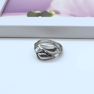 Close-up of vintage punk silver-tone ring featuring a double curved streamline design