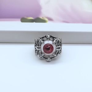 Detailed view of Gothic evil eye ring with realistic red iris and silver metal patterns