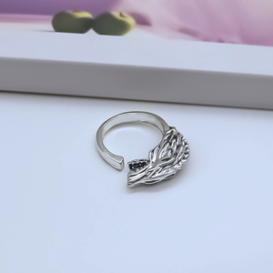 Macro shot of detailed wolf head engraving on a vintage punk style adjustable metal ring