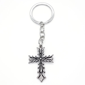 Vintage silver gothic cross keychain with intricate floral engraving and rustic finish