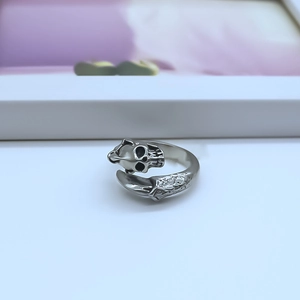 Detailed close-up of a silver punk skull ring with adjustable open band and vintage finish