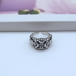 Macro detail of gothic punk adjustable ring with black vintage cross relief