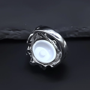 Macro close-up of retro silver alloy evil eye ring featuring a detailed mounting base