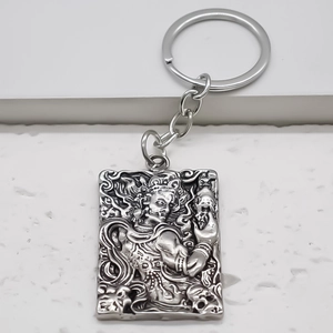 Retro square alloy pendant keychain with embossed mythical deity in silver finish