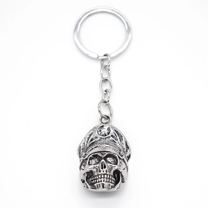 Retro metal skull keychain with army cap and star detail on white background