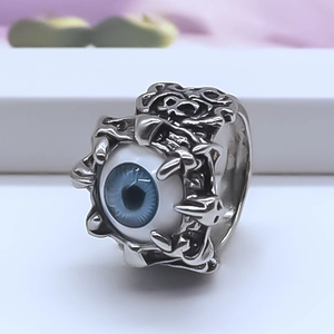 Retro gothic punk silver ring with a realistic blue evil eye and textured relief design