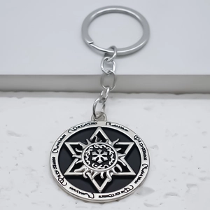 Vintage sun and star totem circular metal keychain with silver finish and black enamel