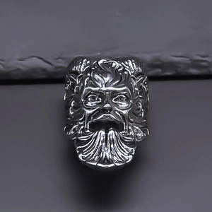 Macro shot of retro silver ring featuring a detailed mythological Pan relief engraving
