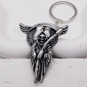 Detailed close-up of a Gothic Grim Reaper keychain with silver wings and scythe
