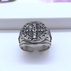 Macro shot of St. Benedict vintage medal ring showing engraved religious symbols