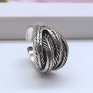 Macro shot of punk style feather ring with retro oxidized finish and adjustable band