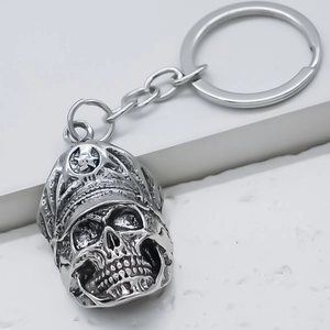 Detailed close-up of a silver alloy skull keychain with a military cap and star badge