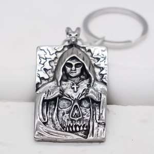 Detailed relief of hooded reaper and skull on gothic style metal rectangle keychain