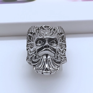 Close-up of vintage wide band ring with detailed relief portrait of a bearded god