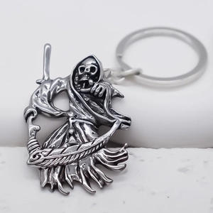 Detailed view of gothic Grim Reaper keychain with oxidized silver scythe carving