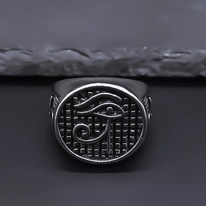 Detail view of vintage stainless steel signet ring with Eye of Horus carving detail