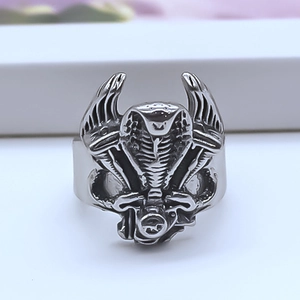 Macro shot of silver cobra ring showing detailed snake scales and vintage punk style texture