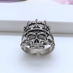 Detailed macro view of an antique silver skull ring with a crown and adjustable band