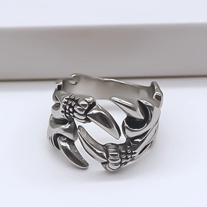 Macro view of vintage eagle claw ring featuring detailed textures and an open band design