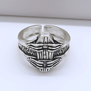 Macro shot of punk cyber robot mask relief on vintage adjustable silver-tone ring