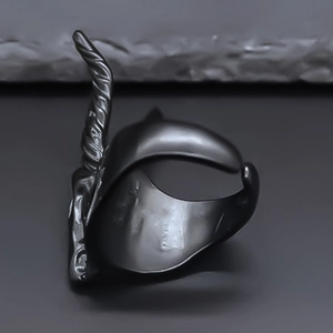Detailed view of matte black sheep head ring with punk gothic textured spiral horns