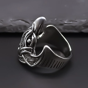 Detail of vintage adjustable ring with Nordic totem engraving and antique silver finish