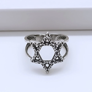 Macro detail of vintage hexagram ring with intricate hollow star pattern and retro finish