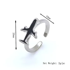 Minimalist silver airplane open ring with black oil drip detail for couples