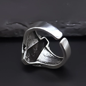 Close-up of vintage silver geometric ring with industrial rock texture and open design