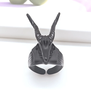 Macro detail of gothic ram head ring showing intricate matte black metal carving