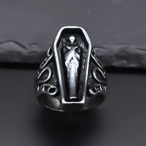 Detail of gothic punk coffin ring showing intricate skull carving and vintage silver finish