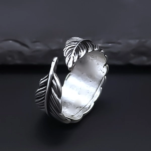 Macro shot of vintage silver feather ring featuring oxidized black details and open design
