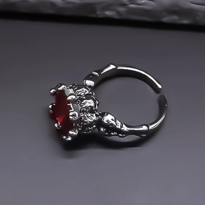 Macro shot of gothic adjustable ring featuring a large red ruby gemstone with claw setting
