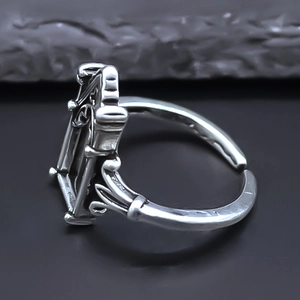 Macro side view of silver vintage open ring showing thick frame and industrial metal carving
