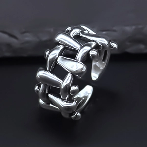 Macro view of adjustable retro silver ring with punk woven chain texture details