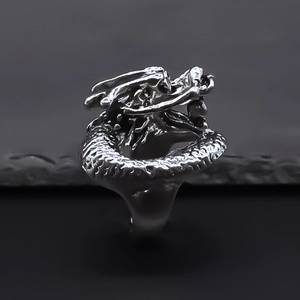 Detailed view of silver dragon ring with intricate scale texture and majestic head carving