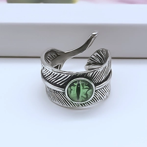 Detailed macro shot of vintage feather ring with green cat eye gemstone center
