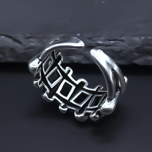 Macro detail of silver geometric lattice cutout ring with vintage industrial matte finish
